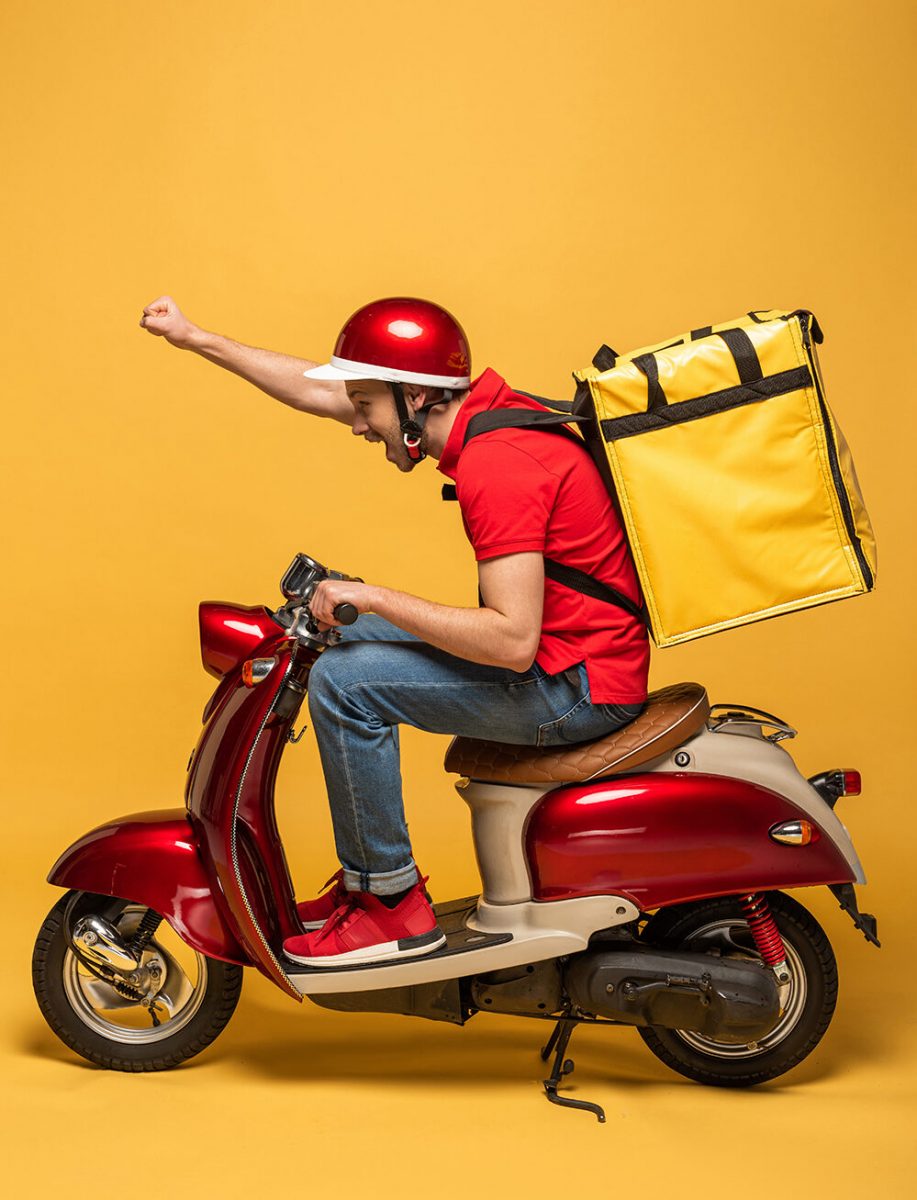 side view of delivery man with backpack on scooter on yellow background